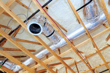 Ductwork insulation are being installed on ceiling in residential renovation project