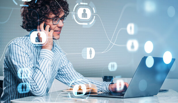 Man in striped shirt talking on phone while working on laptop, digital network icons overlay, modern office background, business communication concept