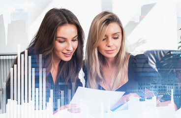 Two women reviewing documents together in a well-lit office, with cityscape and bar chart overlay,...