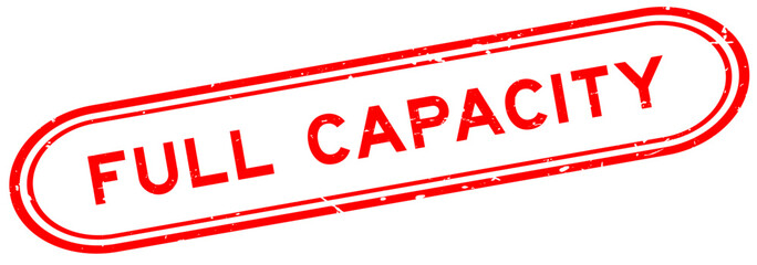 Grunge red full capacity word rubber seal stamp on white background © bankrx