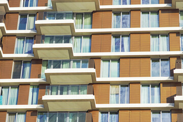 Geometric facade pattern: fragment of the facade with glass balconies, panels and floor-to-ceiling...