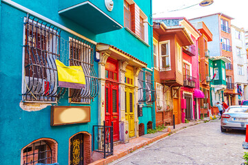 Fototapeta premium Colorful houses in the Balat and Fener districts. Tourists stroll the narrow streets.