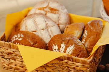 freshly baked sourdough with rustic toppings, artisan bread in basket with flour and oats garnish