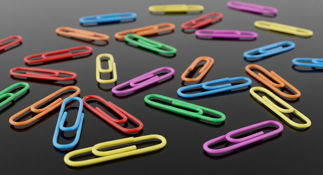 Vibrantly colored plastic paper clips scattered on a reflective dark surface.
A dynamic, close-up photograph featuring a random scattering of brightly colored plastic-coated paper clips