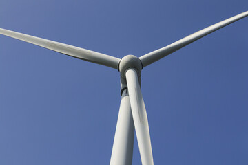 Spinning wind turbine at the rural areas of india. a powerful wind farm for energy production under a sky. Wind mills factory on the hill of gujarat.