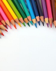 Assortment of colored pencils arranged on a clean white surface. The drawing tools form a vibrant diagonal line, ready for creative projects and artistic expression. Perfect for design inspiration.