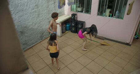 Children playing together in outdoor space, carefree childhood fun, jumping, enjoying simple...