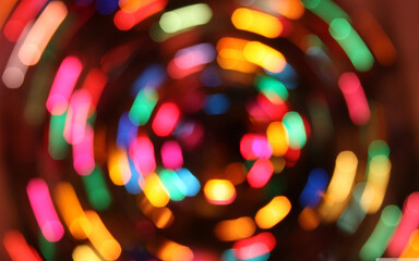 Vibrant abstract bokeh circles of colorful lights in motion, captured with a creative blur effect, representing energy, celebration, and modern art in a dynamic and festive visual composition.

