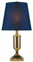 Traditional style table lamp features a tall, polished brass base and a deep navy blue tapered shade