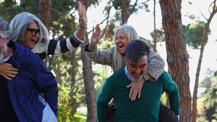 Senior couples enjoying piggyback ride in park