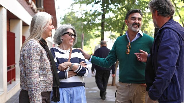 Group of mature adults socializing and laughing outdoor