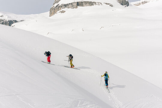 Skiers enjoy a backcountry tour in the Northern Rockies of British Columbia, Canada.