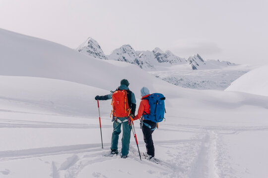 Skiers enjoy a backcountry tour in the Northern Rockies of British Columbia, Canada.