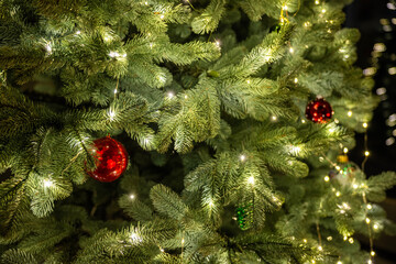 Christmas tree decorated with lights and ornaments in a cozy living room, symbolizing festive holiday spirit and warm family atmosphere © StockMediaSeller