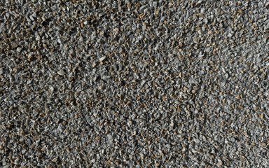Close-up of a background with a dark gray gravel texture