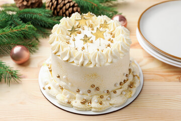 Delicious cake with Christmas decor on light wooden table, closeup