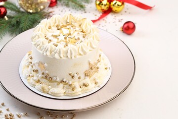 Delicious cake with Christmas decor on white table, closeup