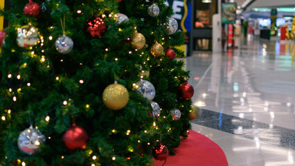 Festive Christmas Tree with Glowing Ornaments in Shopping Mall