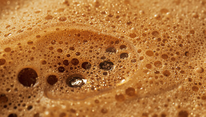 Close-up of frothy coffee with bubbles, highlighting texture and detail for drink design