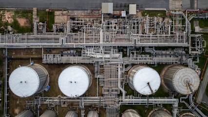 Aerial top view of oil and gas petrochemical storage tank and pipeline steel, Oil and gas transportation system pipeline steel at oil and gas refinery industry chemical plant, Pipeline oil and gas.