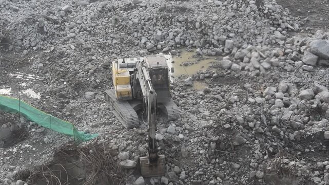 Noida, India , October 31, 2025: Debris of broken building being cleared by heavy machines and workers