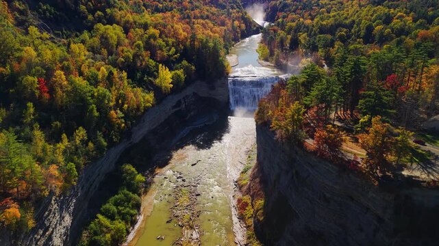 Aerial view of the Genesee River flowing through Letchworth State Park canyon near Rochester, New York, with waterfalls surrounded by colorful autumn forest