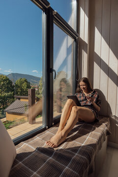 Cozy reading nook with mountain view in a sunny cabin