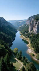 Obraz premium Expansive Aerial View of a Serene Blue Mountain Lake Winding Through a Lush Green Forested Canyon Under a Clear Bright Sky on a Sunny Day
