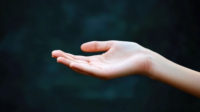 A human hand holding an open palm with a black background. - Powered by Adobe