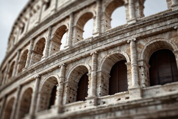 Fototapeta premium Ancient arched stone structure with weathered facade and cloudy sky.