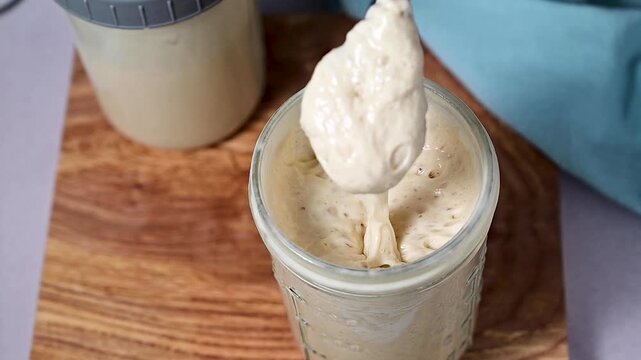 Fresh leaven sourdough starter in glass jars, bright background
