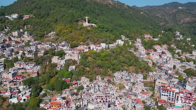 Drone flying over Taxco, approaching Christ statue viewpoint with sweeping mountain scenery