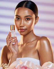 Woman holding gold cap bottle, purple striped background