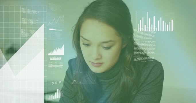 Leaning solo Asian woman analyzing floating data overlays at desk, with grid and bar chart overlays - Powered by Adobe