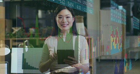 Chinese woman holding tablet and analyzing data in modern office, with laptop and chart overlays