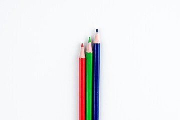 Three Colored Pencils in Red Green and Blue on White Background for Creative Drawing