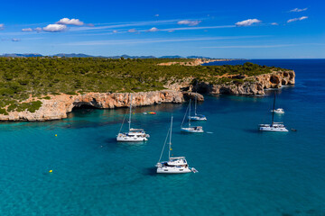 Aerial View of Sailboats Anchored Above Turquoise Waters in a Tranquil Mallorca Bay
