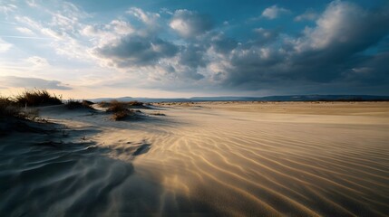 A vast sandy landscape with wind swept dunes rippling sand textures and dramatic clouds at sunset