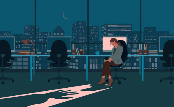 Shadowy hand reaching for woman working in office alone at night