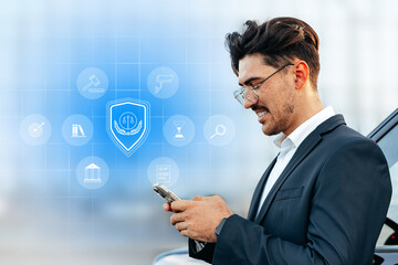 Business professional using smartphone with digital security icons in the background