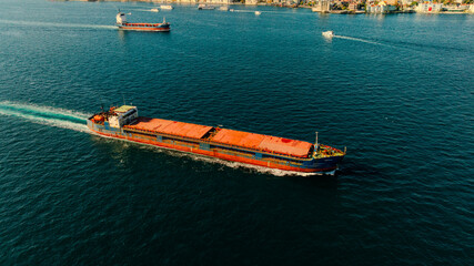 Aerial view of the Bosphorus Bridge with drone on a cloudy day. Tanker ship passing under the FSM Bridge with a heavy car traffic on the bridge.Aerial view of The Second Bosphorus Bridge.