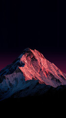 Dramatic snowy summit illuminated by sunset light
