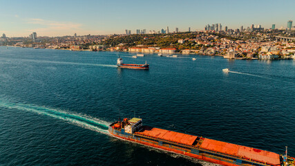 Aerial view of the Bosphorus Bridge with drone on a cloudy day. Tanker ship passing under the FSM Bridge with a heavy car traffic on the bridge.Aerial view of The Second Bosphorus Bridge.