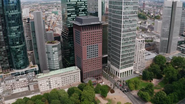Aerial flyover above Frankfurt&rsquo;s financial district, presenting contemporary skyscrapers, diverse architecture, and vibrant urban life at the heart of Europe&rsquo;s economic capital.