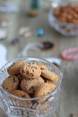 Various Christmas decorations, cookies, chocolate and nuts on wooden background. Selective focus.