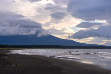 Majestic mountain looms over tranquil beach in Russia's serene coastline