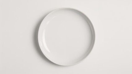Plain white plate on white background. Minimalist dishware, clean design, and simple aesthetic.