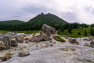 Mountains tower over rocky terrain in a remote Russian landscape