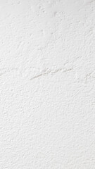 The wall is painted with white paint with a visible texture