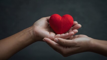 Fototapeta premium A pair of hands gently cradling a red heart representing love, compassion, care and kindness against a soft, neutral backdrop.